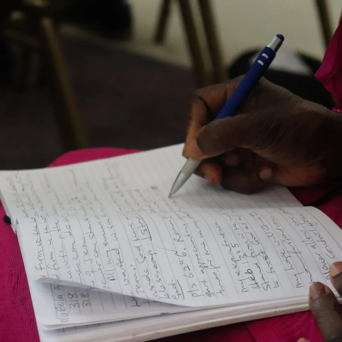 A worshipper taking notes during the message